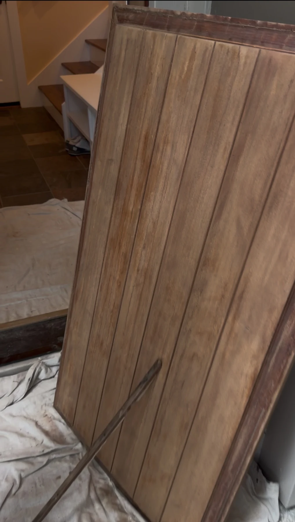 Wood entry door during sanding and preparation